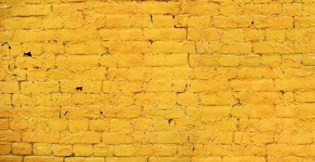 Yellow Brick Wall With Peeling Paint