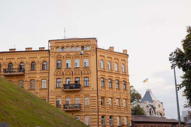 A yellow building with a flag on the top