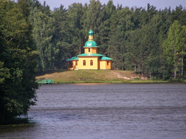 A yellow building with a green roof