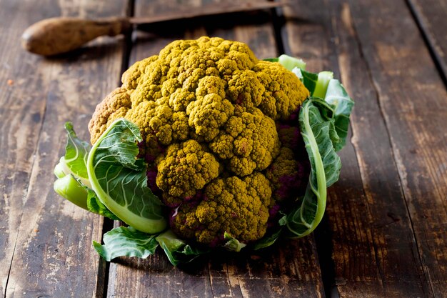 Yellow cauliflower on dark wood