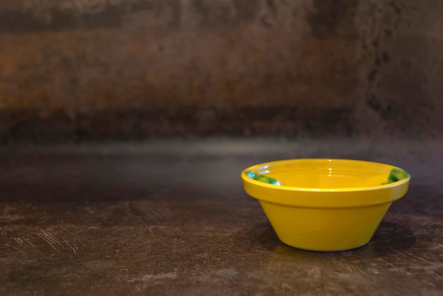 Yellow ceramic bowl. Dark background