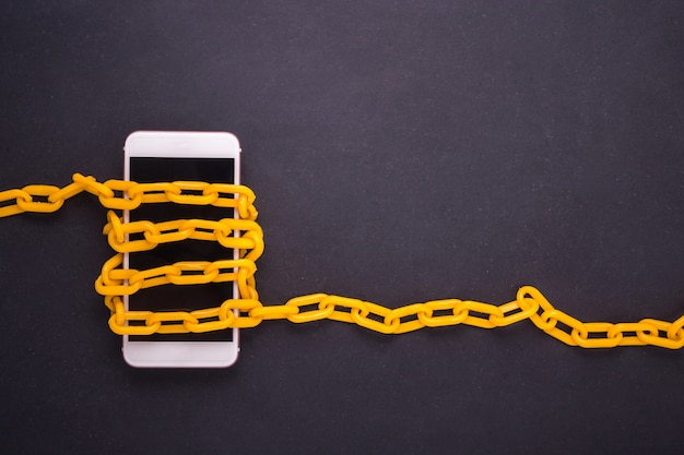 Yellow chain locked around the smartphone