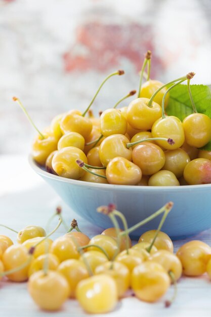 Yellow cherry in a bowl  on the background of a vintage brick wall