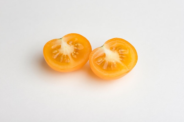 Yellow cherry tomatoes on white.