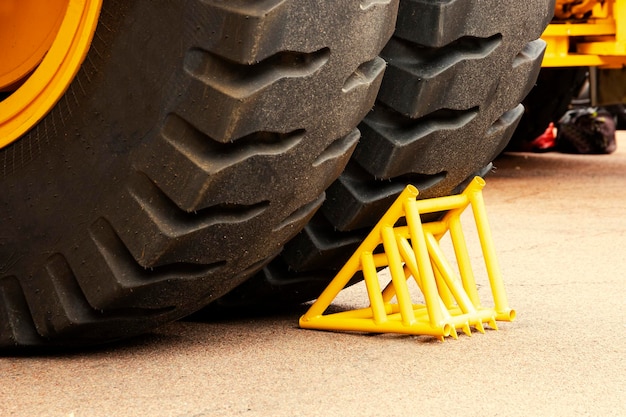 Yellow chock wheel chock under the wheel of a mining truck
brake shoe security engineering