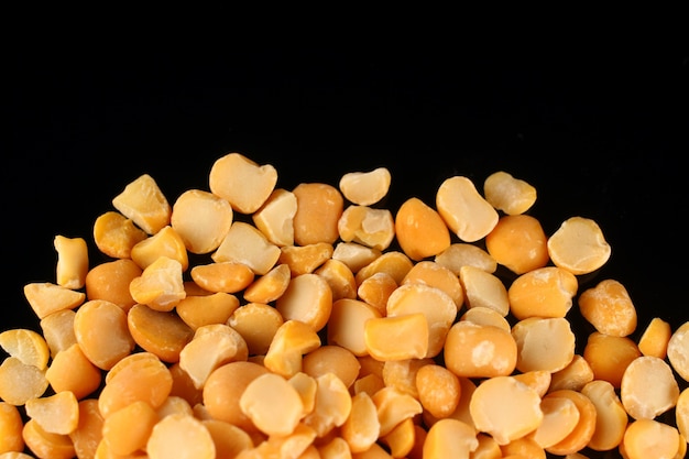 Yellow chopped peas on a black surface place