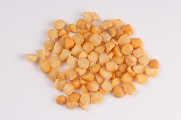 Yellow chopped peas on a white surface