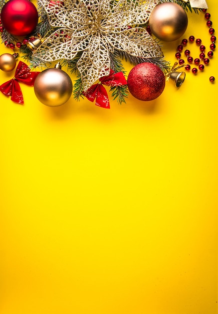 Yellow christmas background decorated with fir tree and toys