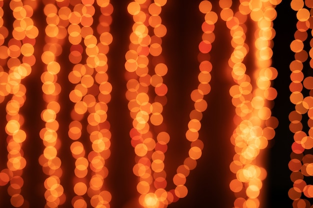 Yellow Christmas Tree Bokeh on black of defocused glittering lights