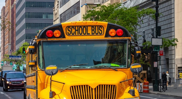 Photo yellow classic public school bus on the street new york manhattan downtown