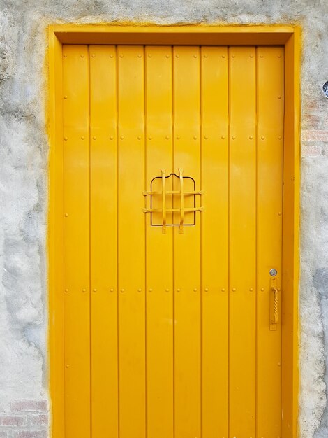 Yellow closed door of building