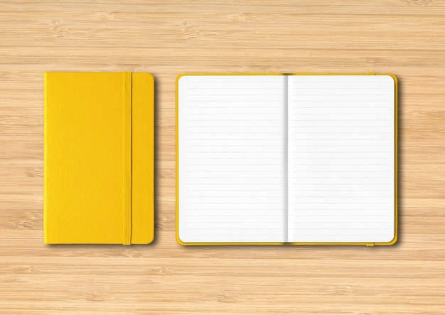 Yellow closed and open lined notebooks mockup isolated on wooden background