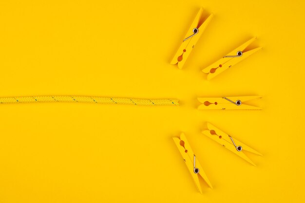 Yellow clothespins and rope. Catch your luck. Yellow background. Lucky break concept.