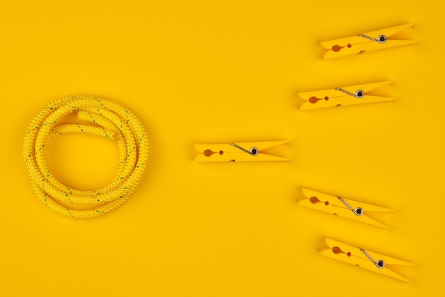 Yellow clothespins and rope