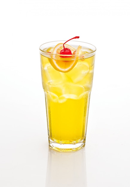 Yellow cocktail decorated with cherry and lemon isolated on white.