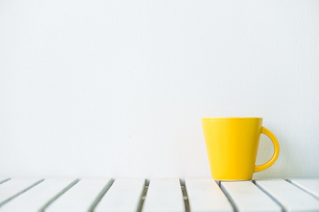 Yellow coffee cup on table