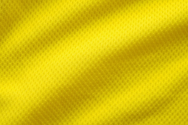 Yellow color football jersey clothing fabric texture sports wear background, close up