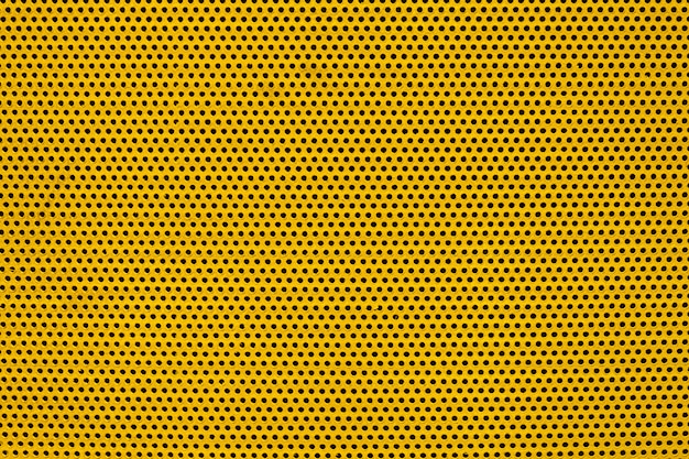 Yellow color metal plate with many small circular holes dots texture for background