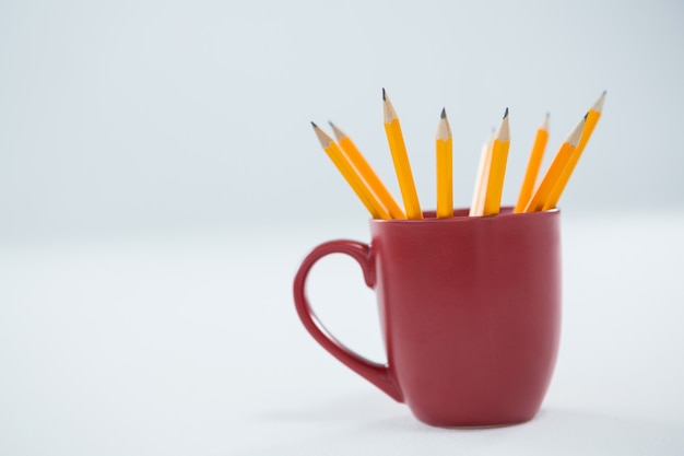 Yellow color pencils kept in mug