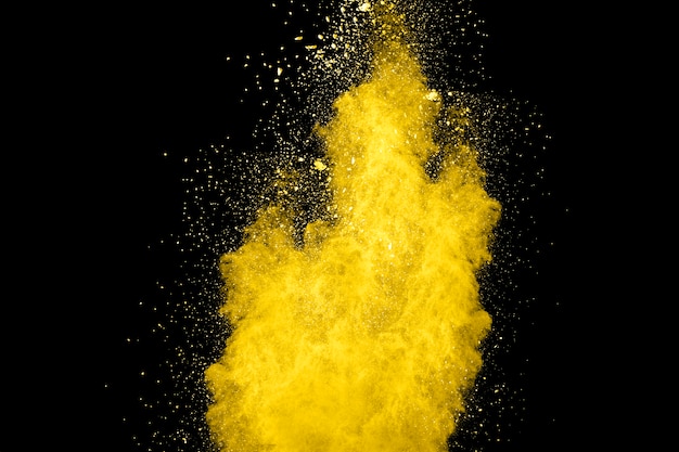 yellow color powder explosion on black background.