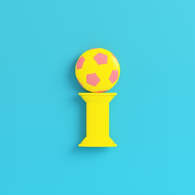 Yellow column with soccer ball on bright blue background in pastel colors