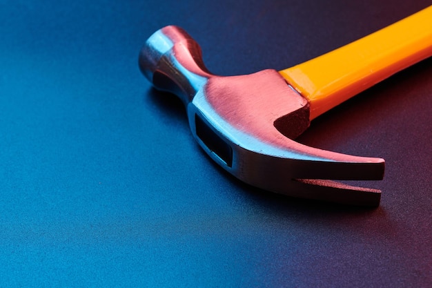 Yellow construction hammer isolated on black background closeup