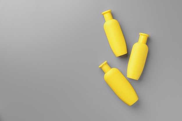 Yellow cosmetic container on gray