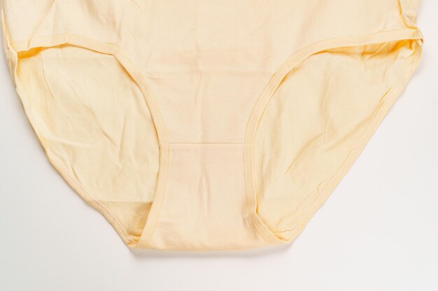 A yellow cotton panties on a white background