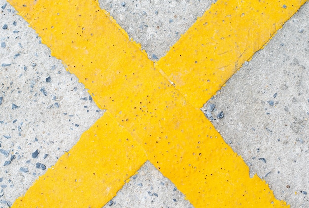 Photo yellow cross symbol on the road