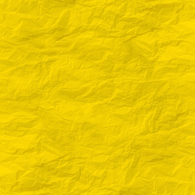 Yellow crumpled paper close up texture background