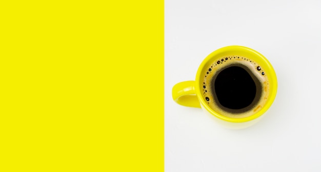 Фото Желтая чашка кофе на цветном фоне