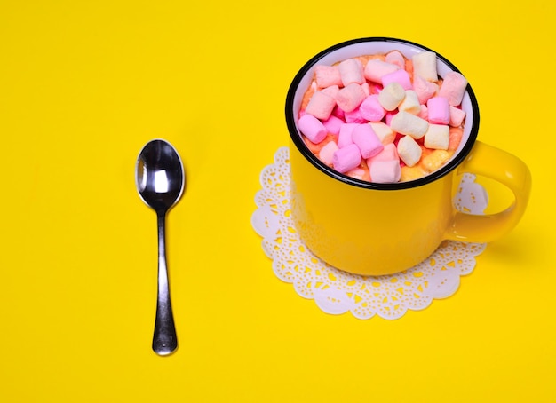 Yellow cup with multicolored marshmallow