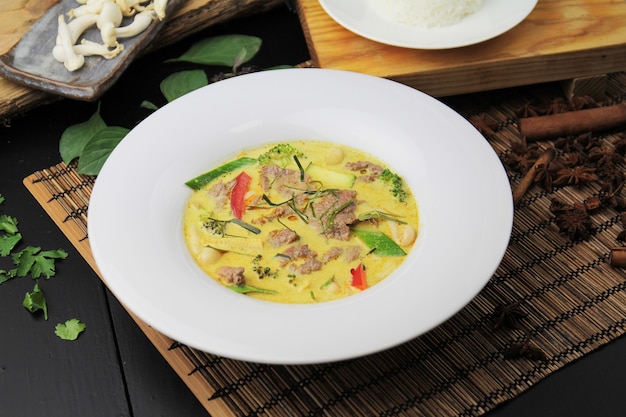 Yellow curry with beef on a white plate