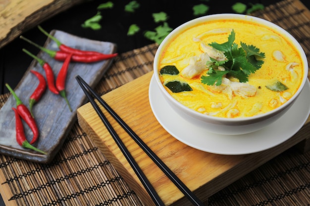 Yellow curry with chicken, in a white bowl and chopsticks