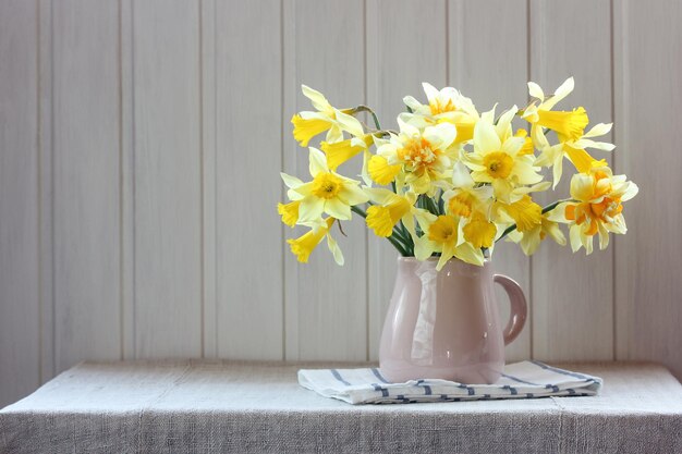 yellow-daffodils-in-a-jug-on-a-table-in-a-light-rustic-interior-spring-flowers_92795-2035.jpg