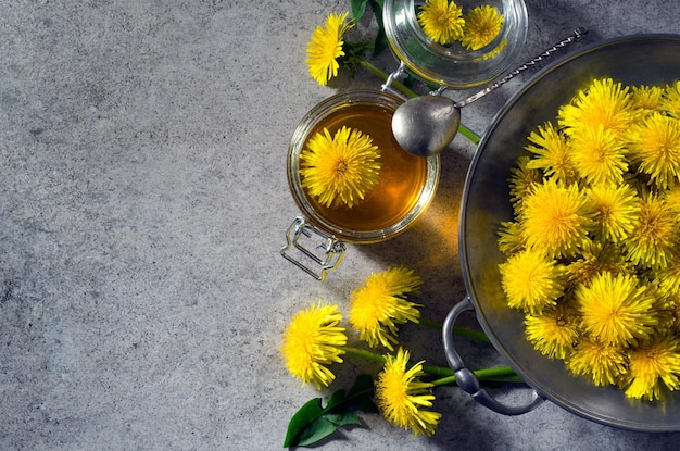 Yellow dandelions and jar of honey