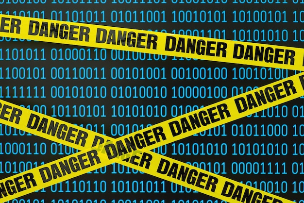 Yellow Danger tape in front of computer screen with binary code Concept of information online security cyber attack