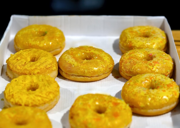 Yellow donuts for Hanukkah celebration on white background Observe Hanukkah with tasteful table set up Traditional Jewish dish sufganiyot with blank area for your text Selective focus Mini donut