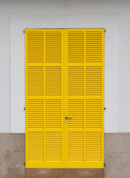 Yellow door framed in a house facade