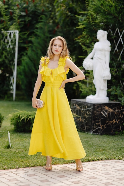 Photo yellow dress with a black belt