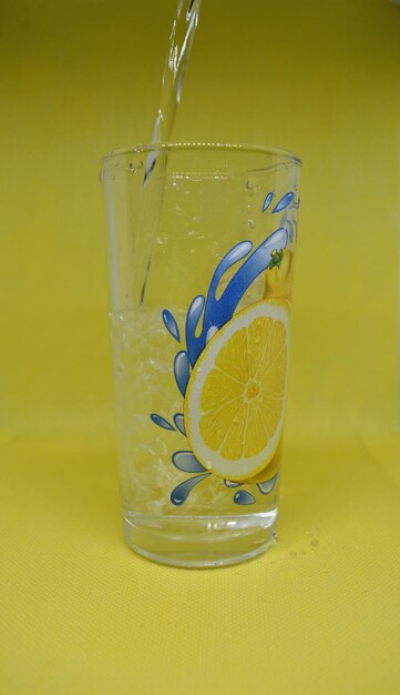 Yellow drink in glass with water