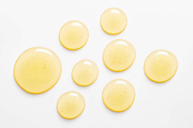 Photo yellow drops of gel close up cosmetic product for moisturizing the skin of the face or body