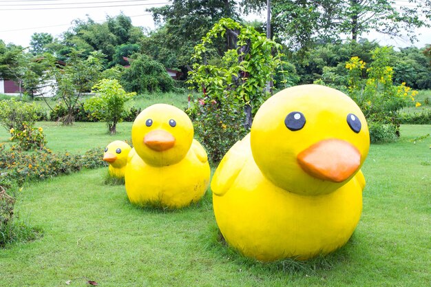 Yellow ducks decoration sculpture on green grass