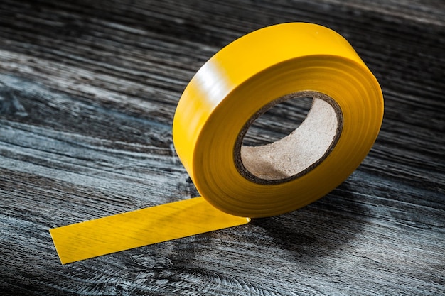 Yellow duct tape on vintage wooden board