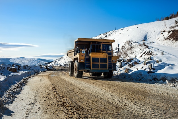 Yellow dump truck on a road