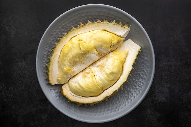 Yellow durian monthong flesh in metal plate on dark texture background, king of fruits