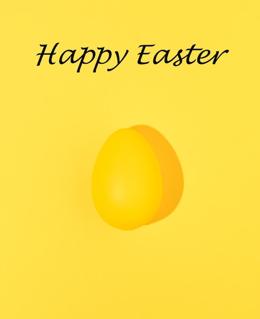 Yellow Easter egg isolated on yellow background Minimal food concept Monochromatic composition