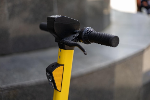 Photo yellow electric scooter with black handlebar