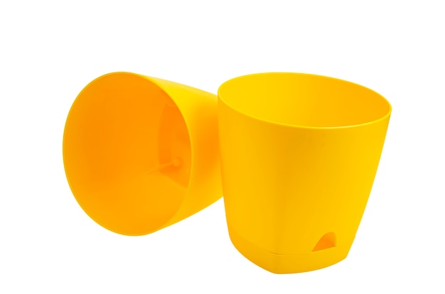 Yellow empty plastic flower pots isolated on white