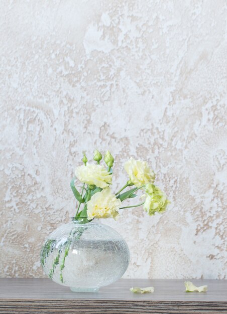 Yellow eustoma in  glass vase on table